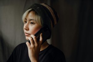 Photo by Ketut Subiyanto: https://www.pexels.com/photo/serious-female-making-call-on-mobile-near-dark-studio-background-4350303/